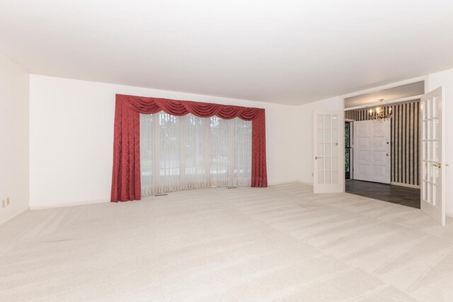212 Mays Dr, Bloomington, IL 61701 - carpeted empty room featuring french doors