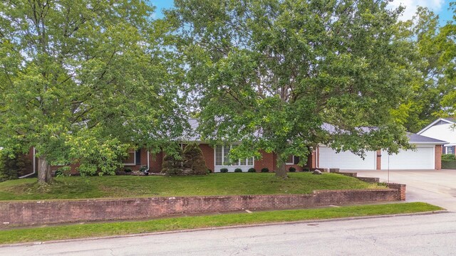212 Mays Dr, Bloomington, IL 61701 - view of front facade featuring concrete driveway, a front yard, an attached garage, and brick siding