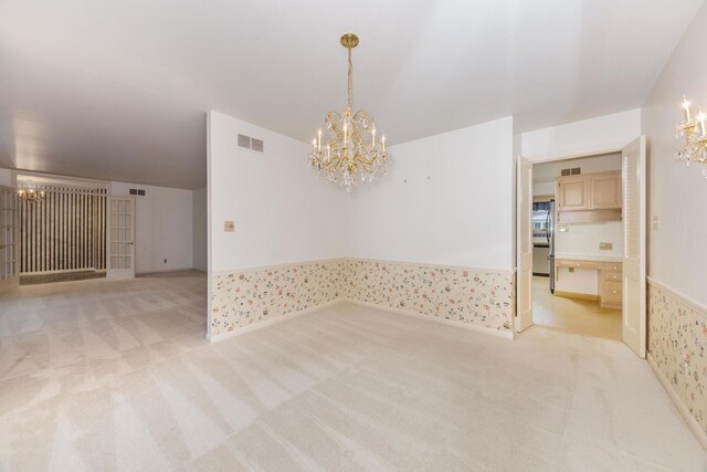 212 Mays Dr, Bloomington, IL 61701 - empty room featuring a chandelier, light carpet, and a wainscoted wall