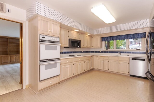 212 Mays Dr, Bloomington, IL 61701 - kitchen with white appliances, light countertops, light wood finished floors, a sink, and cream cabinets