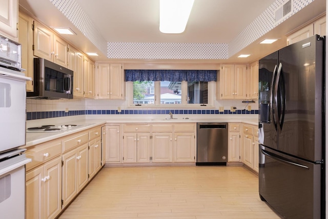 212 Mays Dr, Bloomington, IL 61701 - kitchen with stainless steel appliances, light countertops, light wood-style floors, backsplash, and a sink