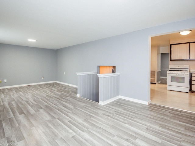 444 S Tanner Ave, Kankakee, IL 60901 - unfurnished living room featuring light wood finished floors and baseboards