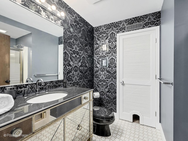 241 E Burlington St Unit A, Riverside, IL 60546 - bathroom featuring wallpapered walls, toilet, vanity, and a shower with shower door