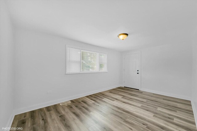 10002 S Torrence Ave, Chicago, IL 60617 - empty room featuring wood finished floors and baseboards