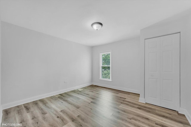 10002 S Torrence Ave, Chicago, IL 60617 - unfurnished bedroom featuring wood finished floors, baseboards, and a closet