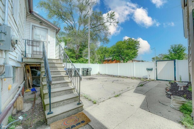 10002 S Torrence Ave, Chicago, IL 60617 - fenced backyard with a patio, a gate, and stairway