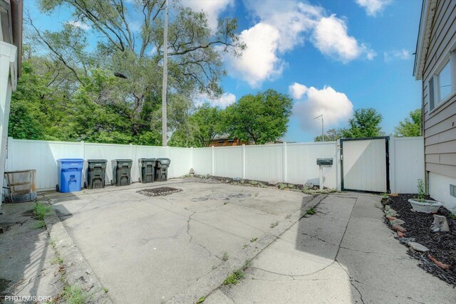 10002 S Torrence Ave, Chicago, IL 60617 - fenced backyard featuring a patio and a gate