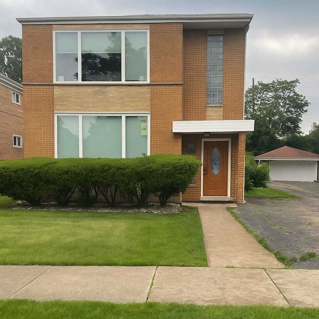 1244 Westchester Blvd, Westchester, IL 60154 - view of front of home with brick siding, a front yard, and a detached garage