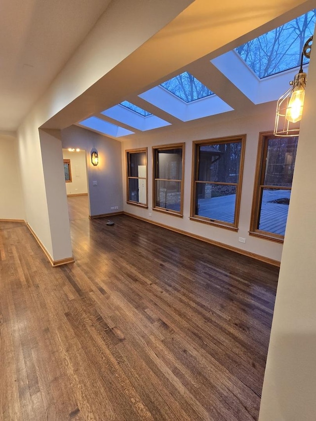 775 Thornmeadow Rd, Riverwoods, IL 60015 - unfurnished living room featuring a skylight, wood finished floors, and baseboards
