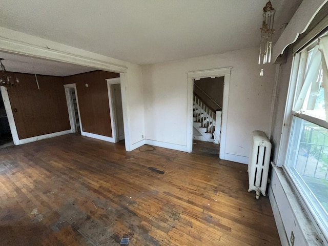 104 Interocean Ave, South Chicago Heights, IL 60411 - spare room with radiator heating unit, wood-type flooring, stairway, and baseboards