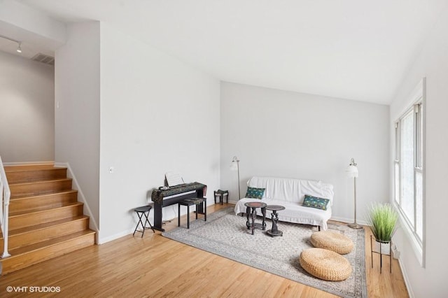 7035 W Greenleaf St, Niles, IL 60714 - living area with wood finished floors, stairs, and track lighting