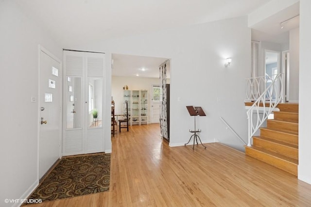 7035 W Greenleaf St, Niles, IL 60714 - foyer featuring light wood-style floors, stairway, and vaulted ceiling