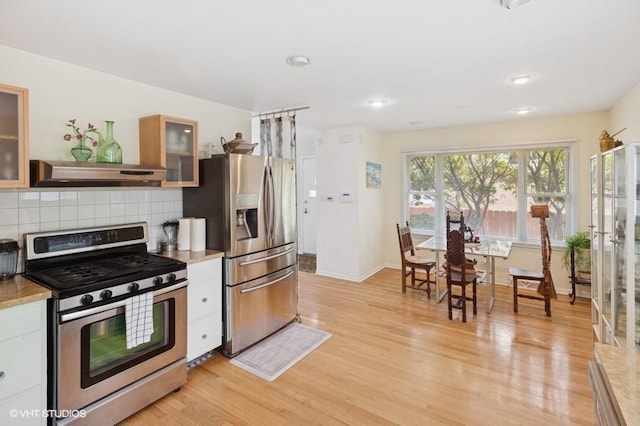 7035 W Greenleaf St, Niles, IL 60714 - kitchen featuring appliances with stainless steel finishes, range hood, light wood finished floors, light countertops, and recessed lighting