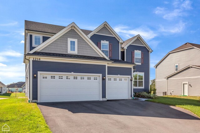 1214 Buckeye Cir, Crystal Lake, IL 60012 - view of front of property with asphalt driveway, a garage, and a front yard