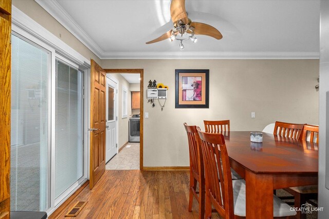 19 Crescent Ct, Montgomery, IL 60538 - dining room with washer / clothes dryer, light wood-style flooring, a ceiling fan, ornamental molding, and baseboards