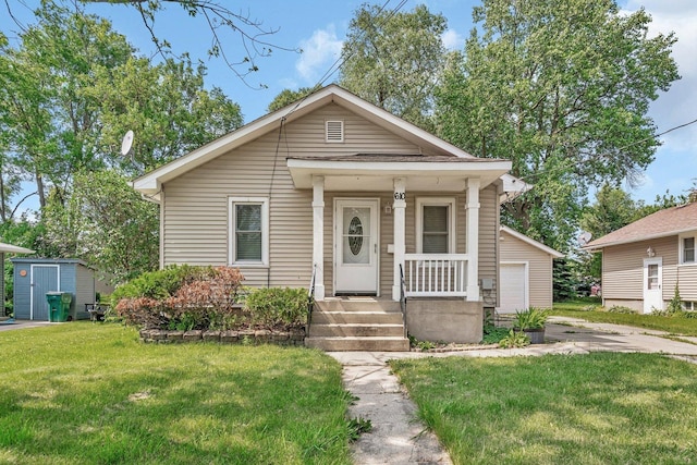 610 W S St, Plano, IL 60545 - view of front of home with a front yard, a porch, and an outdoor structure