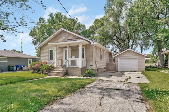 610 W S St, Plano, IL 60545 - shotgun-style home featuring a detached garage, an outdoor structure, asphalt driveway, and a front lawn