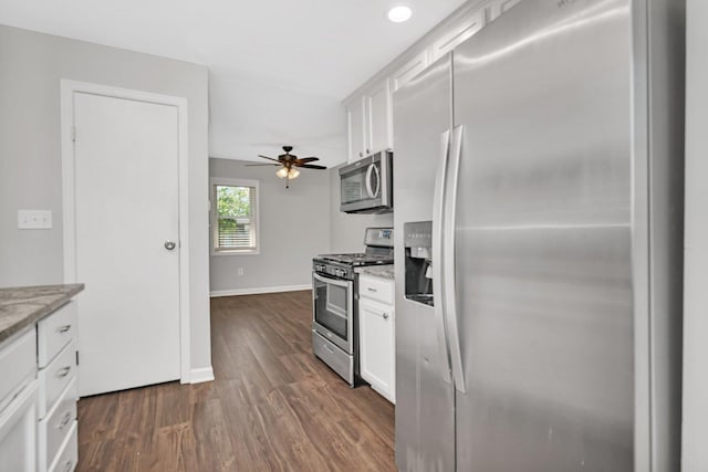 610 W S St, Plano, IL 60545 - kitchen with stainless steel appliances, white cabinetry, dark wood-style flooring, a ceiling fan, and light stone countertops