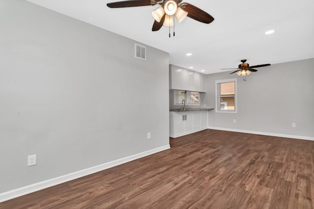 610 W S St, Plano, IL 60545 - unfurnished living room featuring ceiling fan, dark wood-type flooring, and recessed lighting
