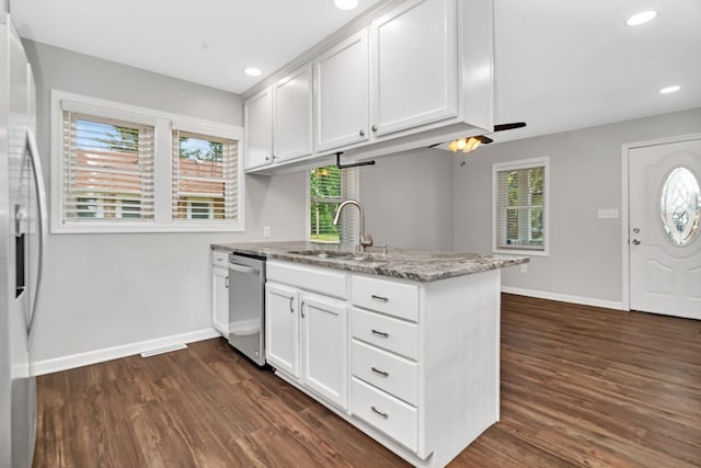 610 W S St, Plano, IL 60545 - kitchen with appliances with stainless steel finishes, a peninsula, dark wood-style floors, white cabinets, and light stone countertops