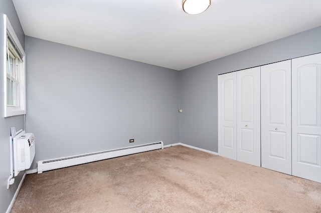 1130 Ontario St Unit B1, Oak Park, IL 60302 - unfurnished bedroom with carpet flooring, baseboard heating, a wall mounted air conditioner, baseboards, and a closet