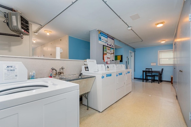 1130 Ontario St Unit B1, Oak Park, IL 60302 - community laundry with washing machine and dryer, a heating unit, and light flooring