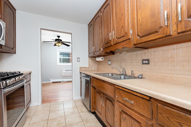 1130 Ontario St Unit B1, Oak Park, IL 60302 - kitchen with stainless steel appliances, a sink, decorative backsplash, a ceiling fan, and light countertops