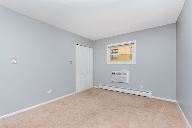 1130 Ontario St Unit B1, Oak Park, IL 60302 - carpeted empty room featuring a baseboard radiator, a wall mounted air conditioner, and baseboards
