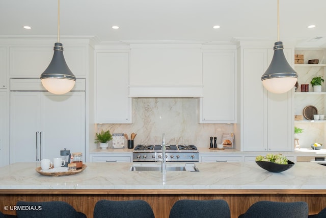 1812 N Howe St Unit Ph, Chicago, IL 60614 - kitchen with a kitchen bar, a sink, light stone countertops, and recessed lighting