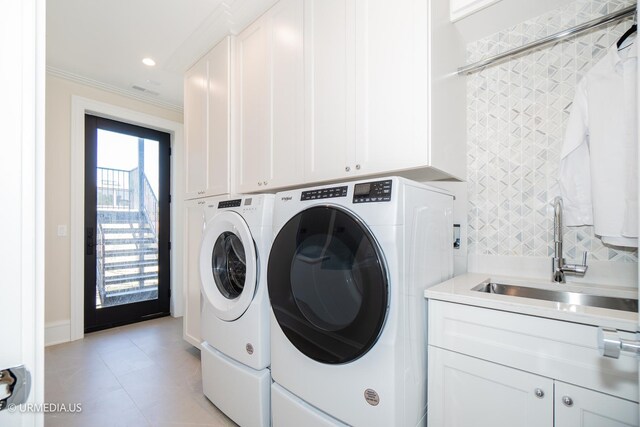 1812 N Howe St Unit Ph, Chicago, IL 60614 - washroom featuring washing machine and dryer, crown molding, cabinet space, and light tile patterned floors