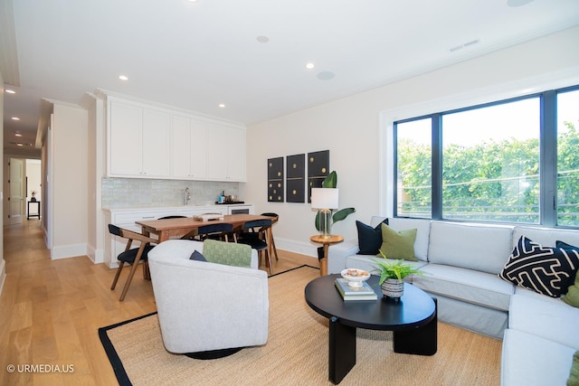 1812 N Howe St Unit Ph, Chicago, IL 60614 - living room with healthy amount of natural light, light wood-style floors, recessed lighting, ornamental molding, and baseboards