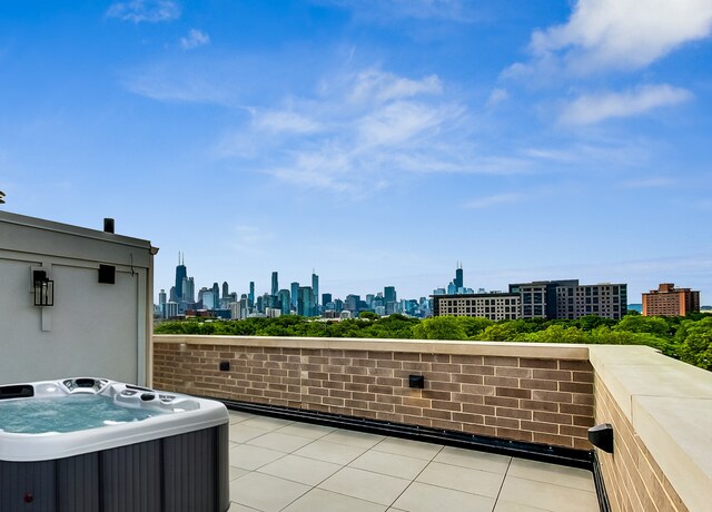 1812 N Howe St Unit Ph, Chicago, IL 60614 - view of patio / terrace with central air condition unit, a hot tub, and a skyline view