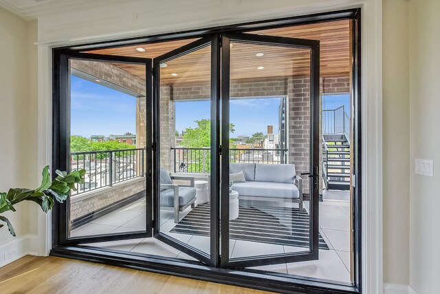 1812 N Howe St Unit Ph, Chicago, IL 60614 - doorway to outside with healthy amount of natural light, wood finished floors, and baseboards