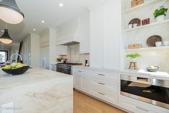 1812 N Howe St Unit Ph, Chicago, IL 60614 - kitchen with open shelves, stove, custom exhaust hood, tasteful backsplash, and white cabinetry