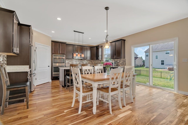 1221 Winding Way, Bolingbrook, IL 60490 - dining space featuring light wood-style flooring, recessed lighting, and ornamental molding