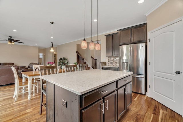 1221 Winding Way, Bolingbrook, IL 60490 - kitchen with stainless steel fridge, a ceiling fan, a kitchen bar, ornamental molding, and open floor plan