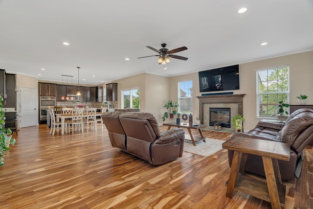 1221 Winding Way, Bolingbrook, IL 60490 - living area featuring light wood finished floors, recessed lighting, ornamental molding, a tile fireplace, and a ceiling fan