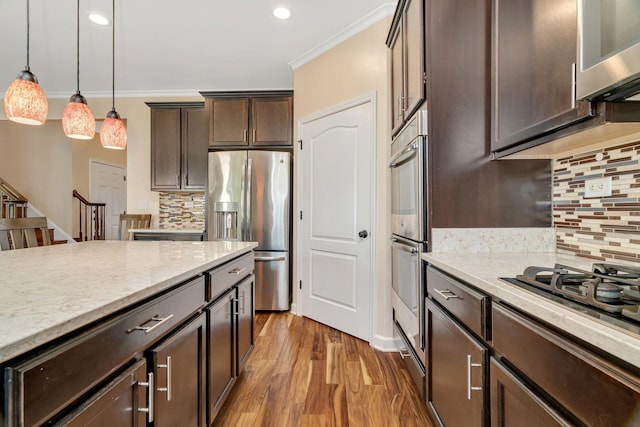 1221 Winding Way, Bolingbrook, IL 60490 - kitchen with stainless steel appliances, dark brown cabinets, backsplash, ornamental molding, and hanging light fixtures