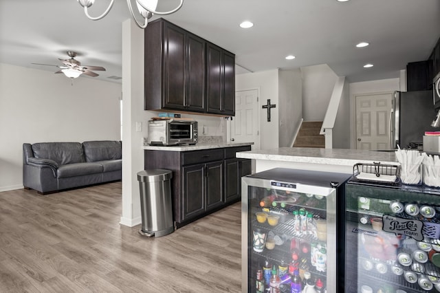 1025 Tuscany Trl, Hampshire, IL 60140 - kitchen with wine cooler, light countertops, freestanding refrigerator, dark brown cabinetry, and ceiling fan