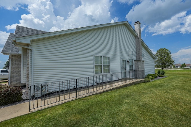 343 White Hawk Way, Manteno, IL 60950 - view of property exterior featuring a lawn, a chimney, and a shingled roof