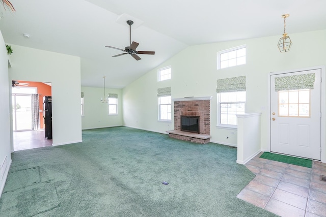 343 White Hawk Way, Manteno, IL 60950 - unfurnished living room featuring ceiling fan, plenty of natural light, a fireplace, and high vaulted ceiling