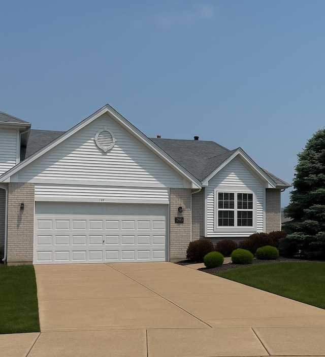 343 White Hawk Way, Manteno, IL 60950 - view of front facade featuring brick siding, a garage, driveway, and a shingled roof