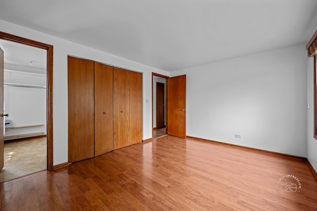 304 Dean Cir, Bolingbrook, IL 60440 - unfurnished bedroom with light wood-style floors and multiple closets