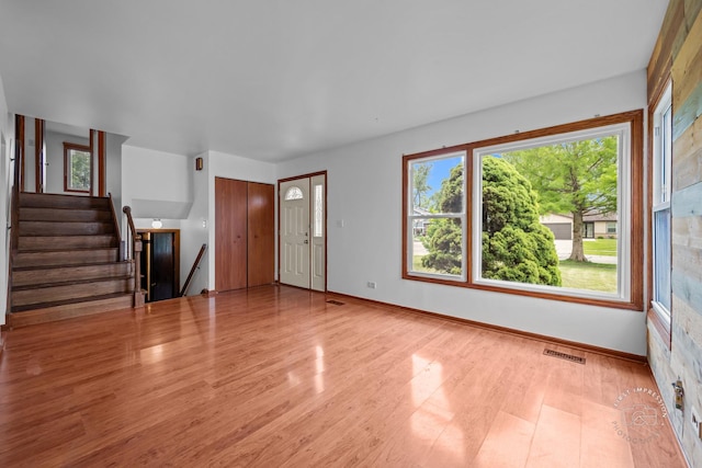 304 Dean Cir, Bolingbrook, IL 60440 - unfurnished living room featuring wood finished floors and stairs