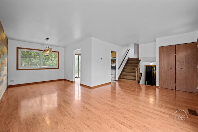 304 Dean Cir, Bolingbrook, IL 60440 - unfurnished living room featuring plenty of natural light, light wood-style flooring, and stairway