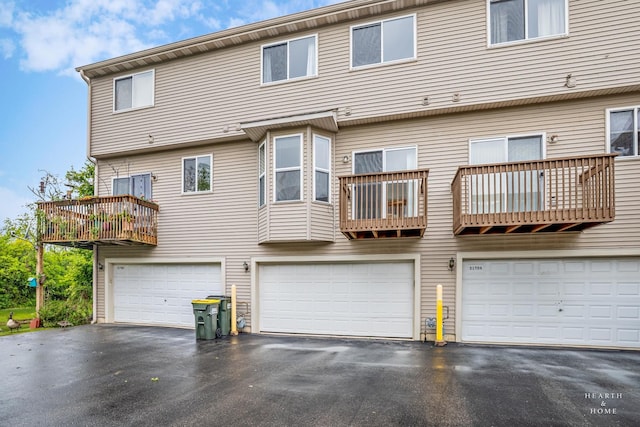 31782 N Pineview Blvd, Lakemoor, IL 60051 - rear view of house with a balcony, a garage, and driveway