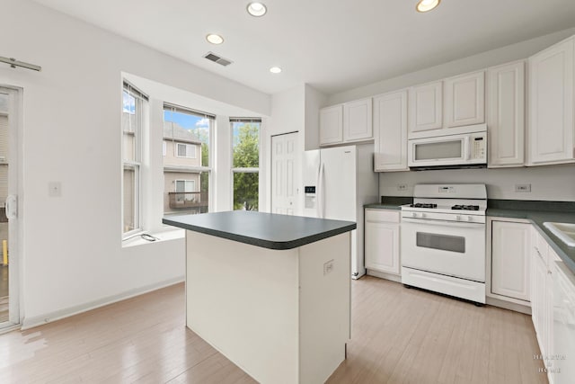 31782 N Pineview Blvd, Lakemoor, IL 60051 - kitchen with white appliances, dark countertops, recessed lighting, and white cabinetry