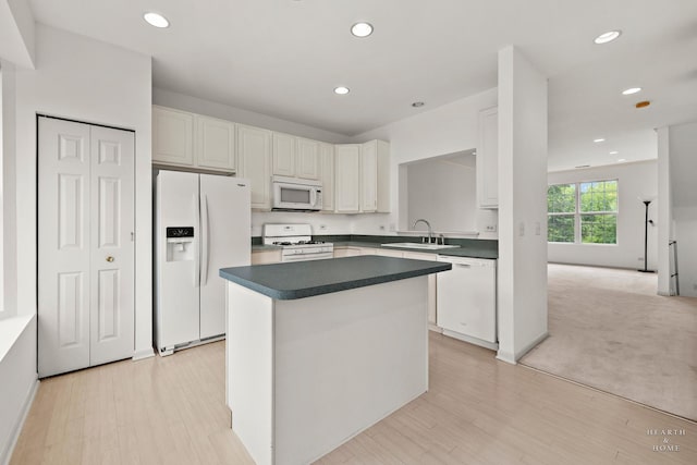 31782 N Pineview Blvd, Lakemoor, IL 60051 - kitchen with white appliances, a sink, a kitchen island, recessed lighting, and white cabinetry