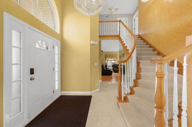 7623 Beringer Ct, Gurnee, IL 60031 - tiled foyer entrance featuring a towering ceiling, stairs, and a chandelier