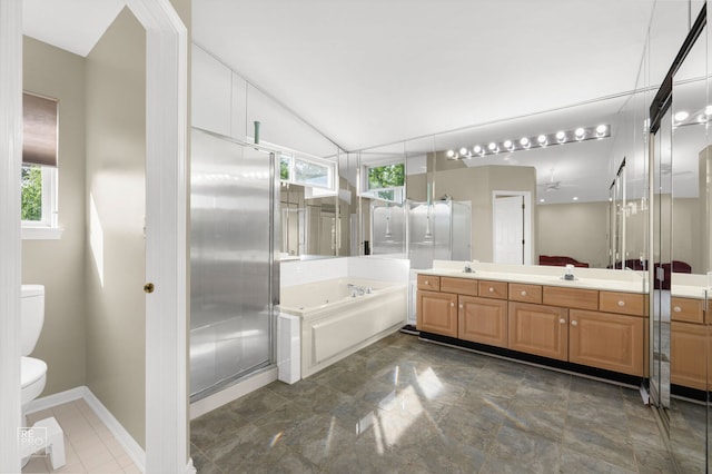 7623 Beringer Ct, Gurnee, IL 60031 - bathroom featuring a bath, vanity, lofted ceiling, and stone finish floors